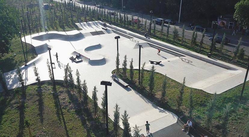 Aerial view of Varketili Skatepark in Tbilisi: a large concrete park with bowl transitions, ledges and rails surrounded by young trees