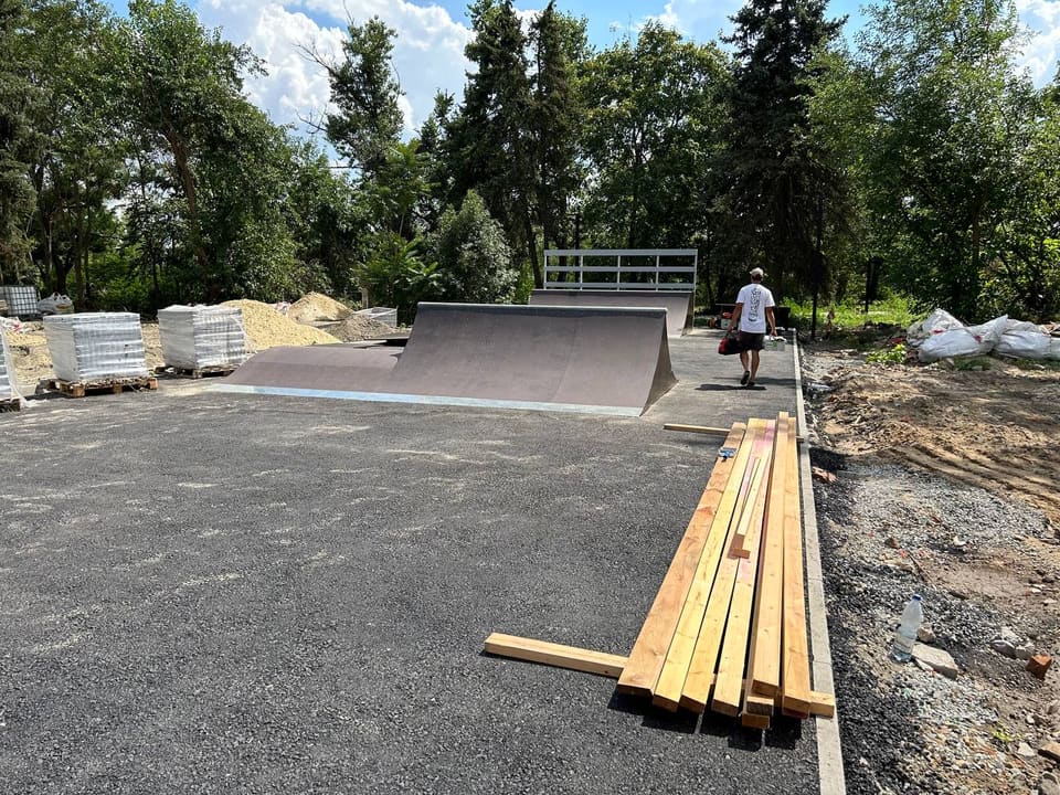 New asphalt pad with timber stacked for on-site assembly