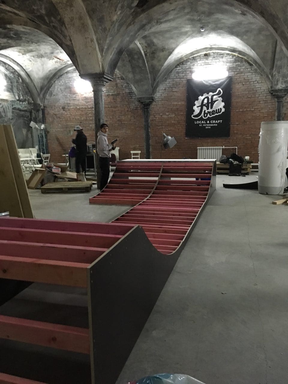 Ramp frames being assembled in a vaulted brick hall