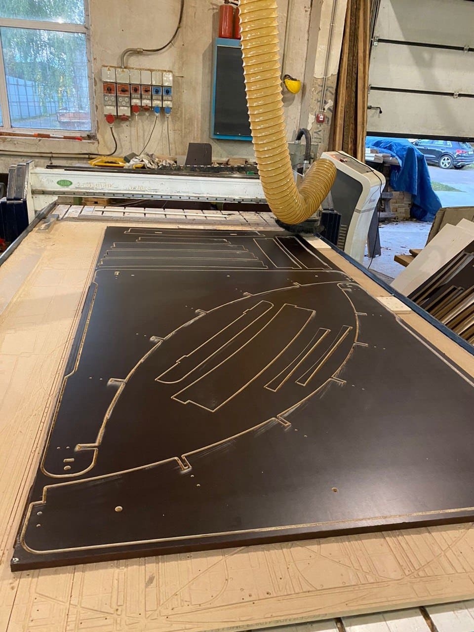 CNC machine cutting ramp side panels from plywood